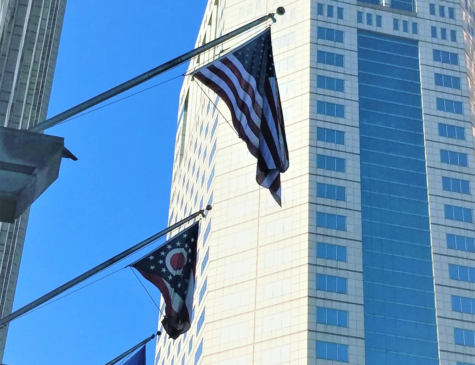 The Ohio and American flags fly in downtown Columbus